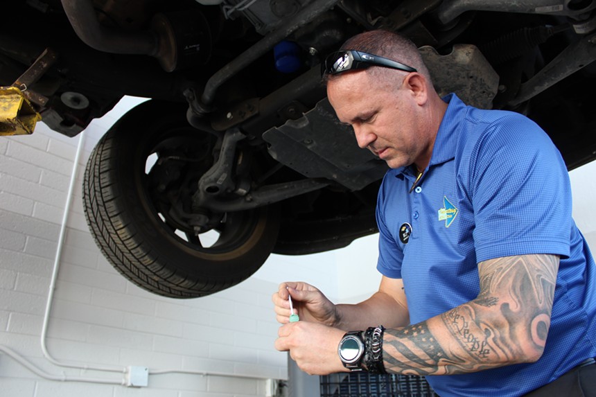 Shop foreman Billy Blandford prepares a liquid sealant that holds the SafeCat identification number onto each catalytic converter. - ELIAS WEISS