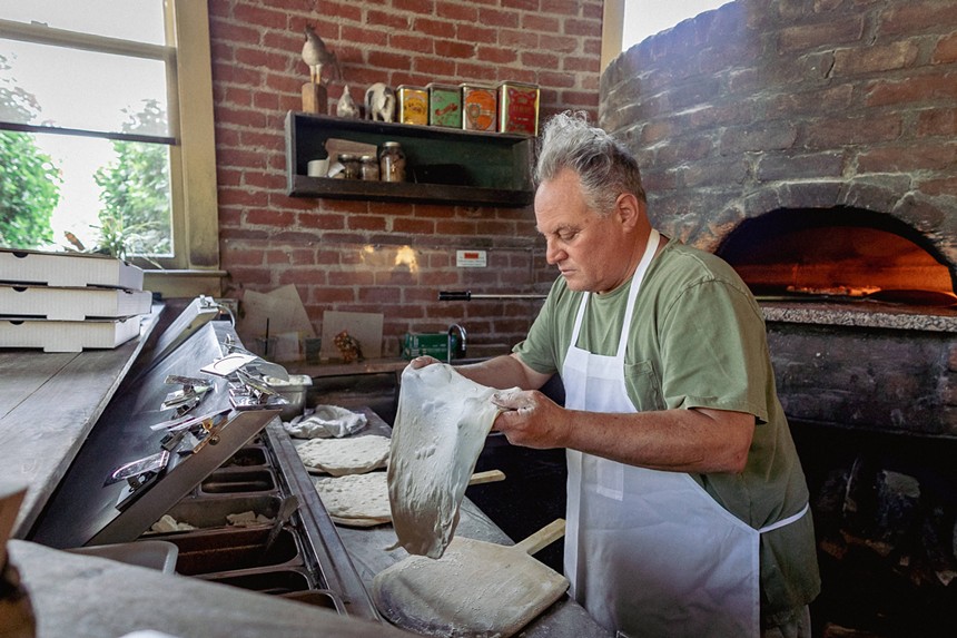 Chris Bianco stretches dough at his pizzeria in downtown Phoenix. - JACOB TYLER DUNN