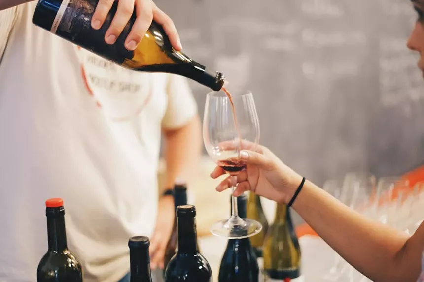 Pouring wine into a glass.