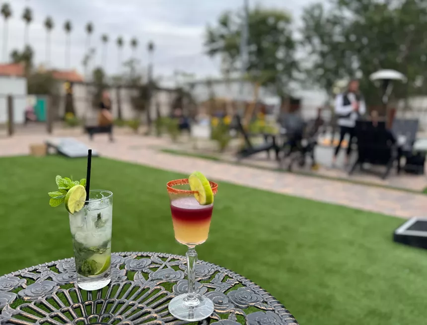 Two Maple House drinks on a patio table.