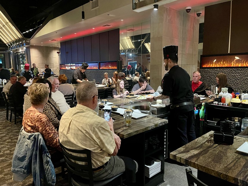 Customers sit around a tabletop grill at Kasai.