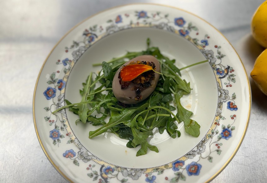 A tea egg on a bed of greens.