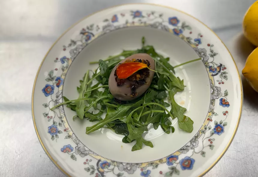 A tea egg on a bed of greens.