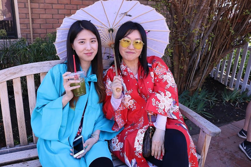 Two women sitting together in Japanese dress.