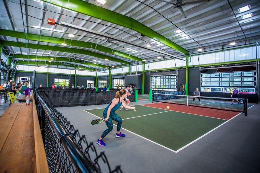 Four people playing pickleball.