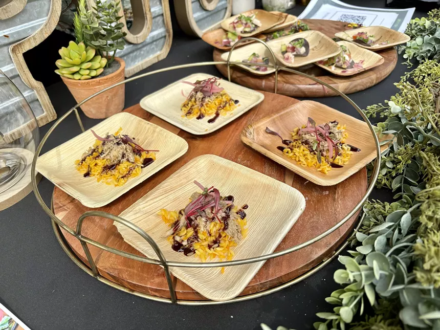 Four plates of chicken and rice on a tray.