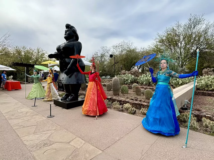 Fernando Botero sculpture and colorfully dressed artists.