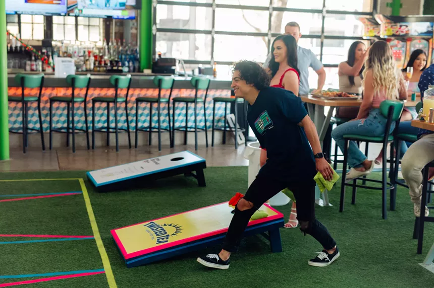 People playing corn hole at Backyard at Desert Ridge.
