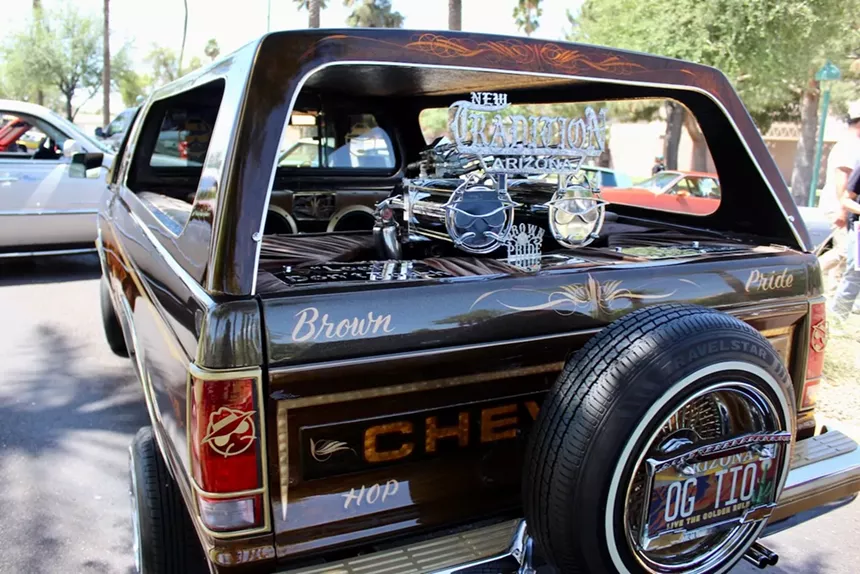 The back of a customized Chevrolet car with a spare tire attached.