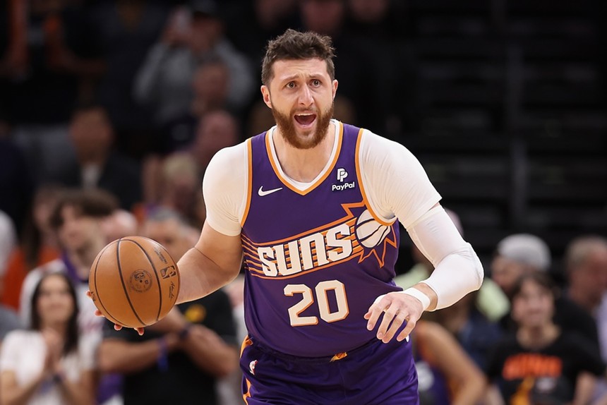 A bearded basketball player in a purple Suns jersey dribbles. He wears No. 20.