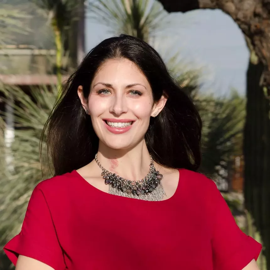A woman in a red dress with dark brown hair.