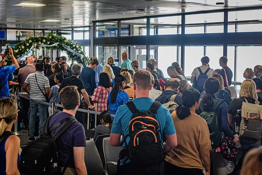A crowd outside an airport terminal