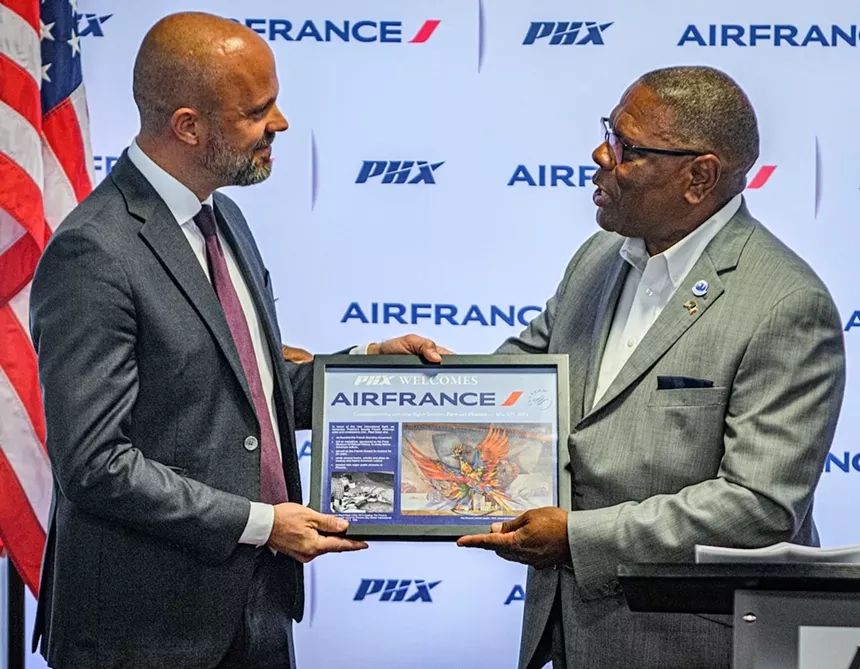 Two men exchange a plaque