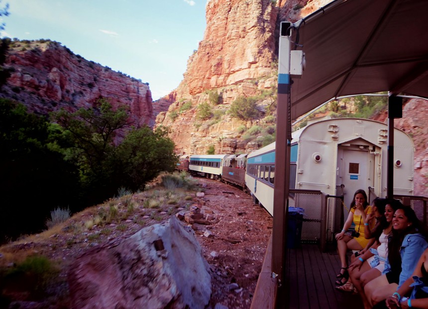 People on an open-air train car.