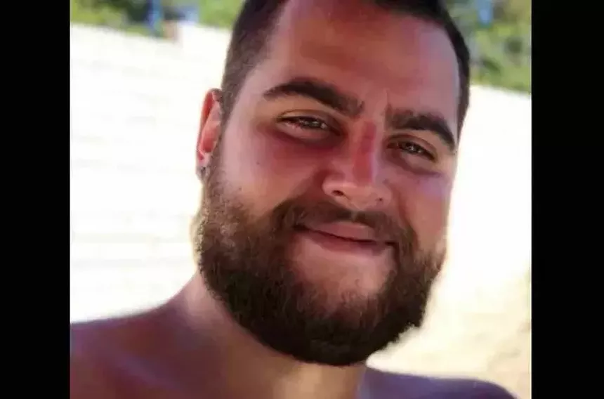 A bearded, smiling man
