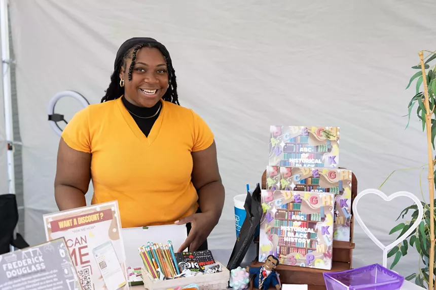 A woman working a table at an event.
