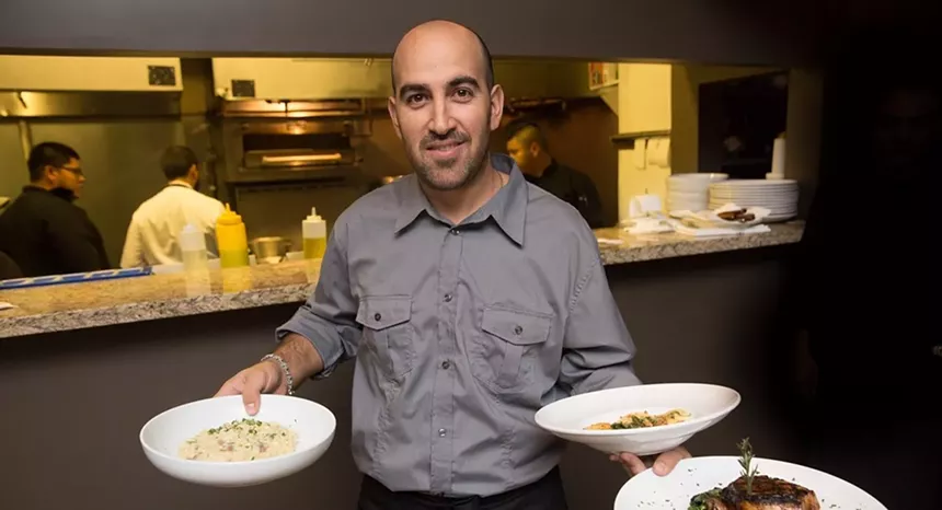 A waiter holding plates
