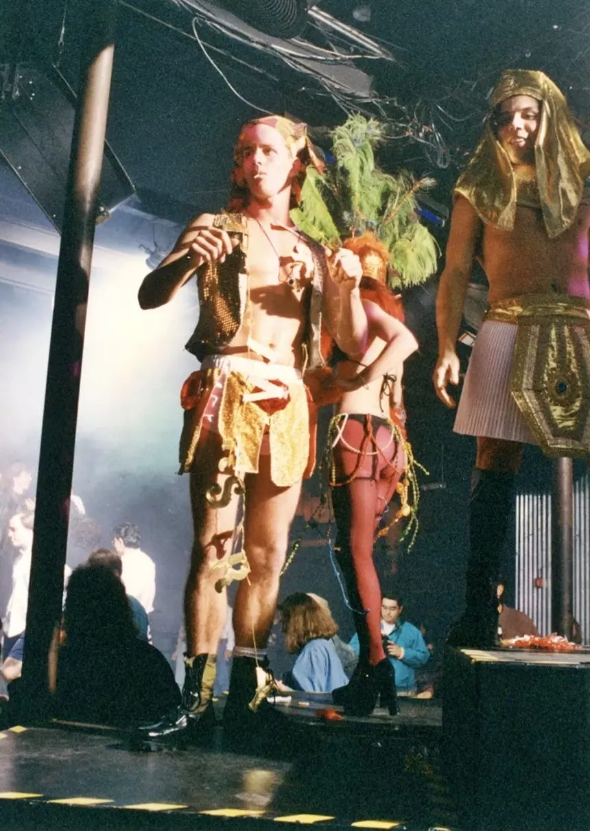 People in costume walking down a catwalk.