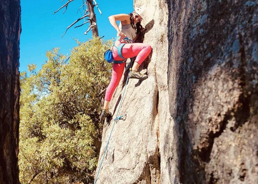 A woman rock-climbing.