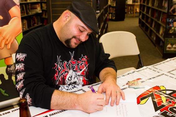 A man signing a book.