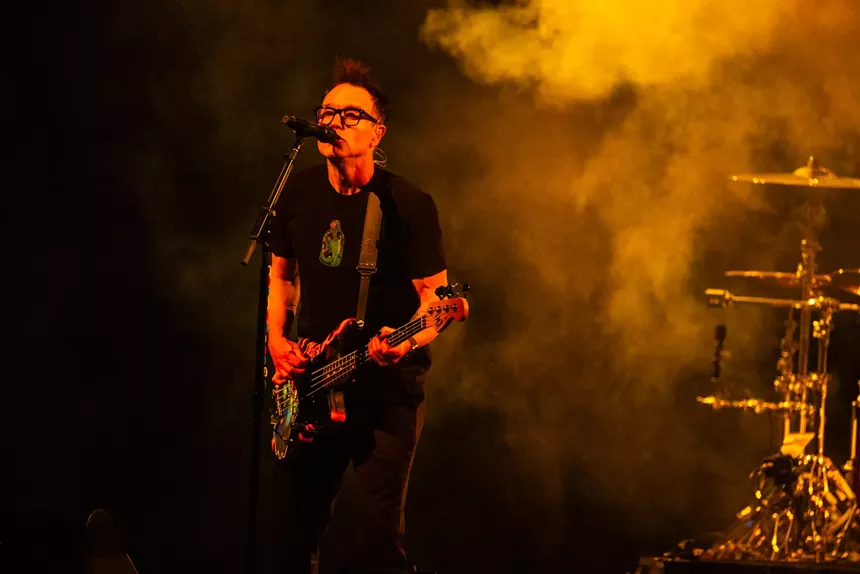 A man playing a bass guitar.