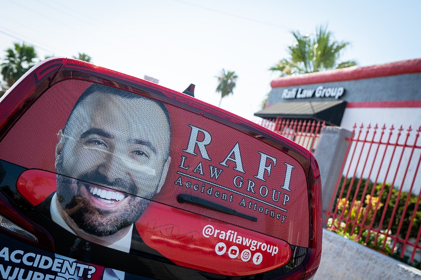 A truck outside of Rafi Law Group with Brandon Rafi's face on it