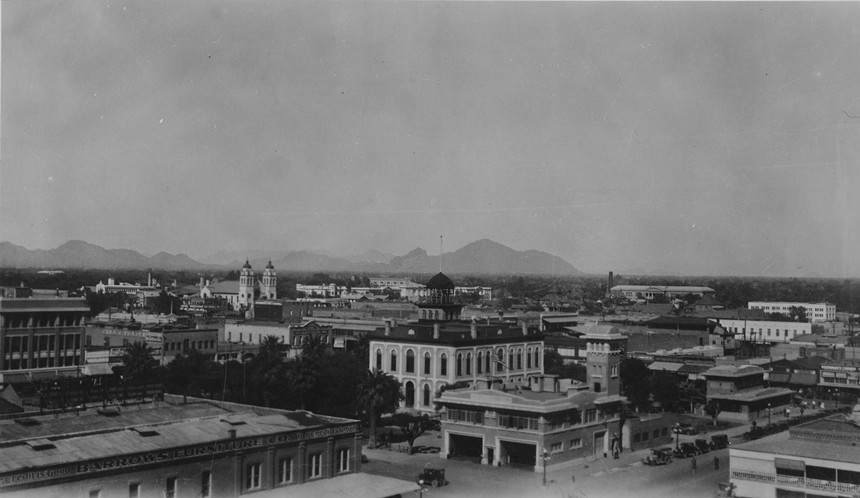 a 1920s picture of downtown Phoenix. St. Mary's Basilica and Camelback Mountain can be seen.