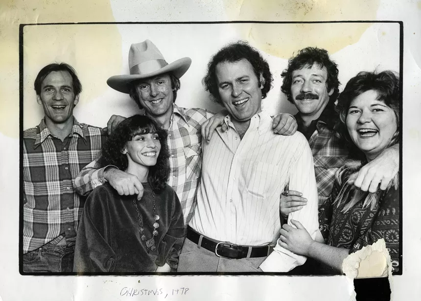 A black and white photo of a group of white people.