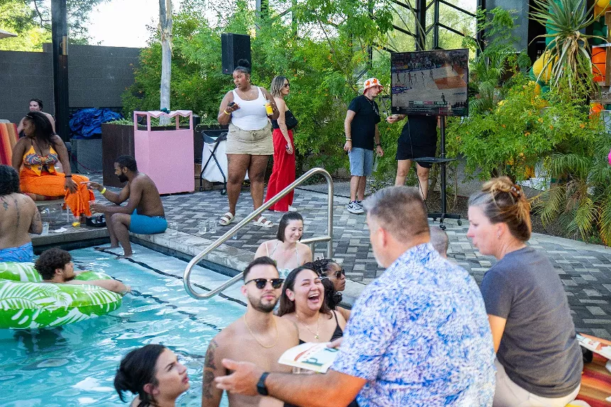 People in a pool with TVs nearby