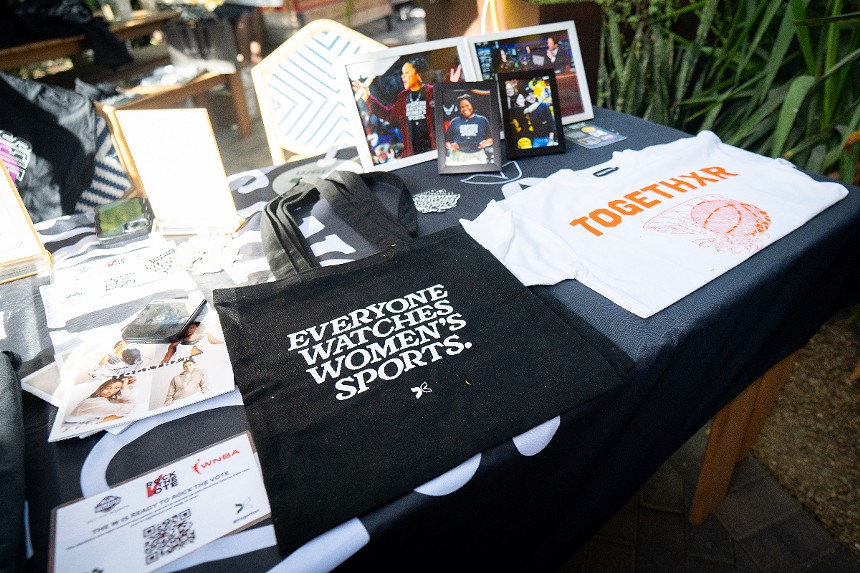 A table of bags, shirts and other merchandise from Togethxr