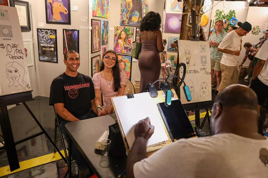 An artist drawing a couple.