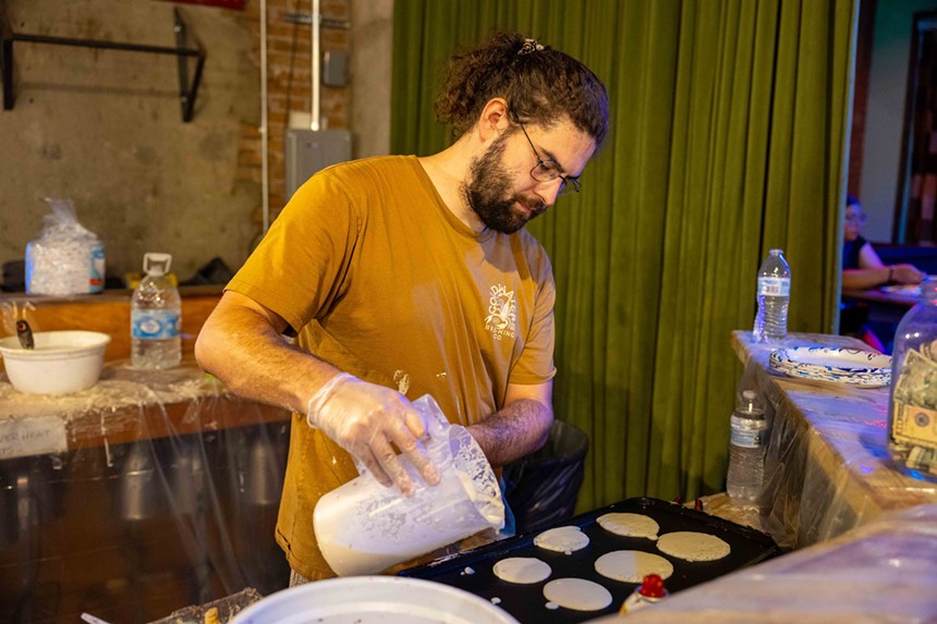 A man making pancakes.