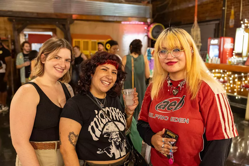 Three young women posing for a photo.