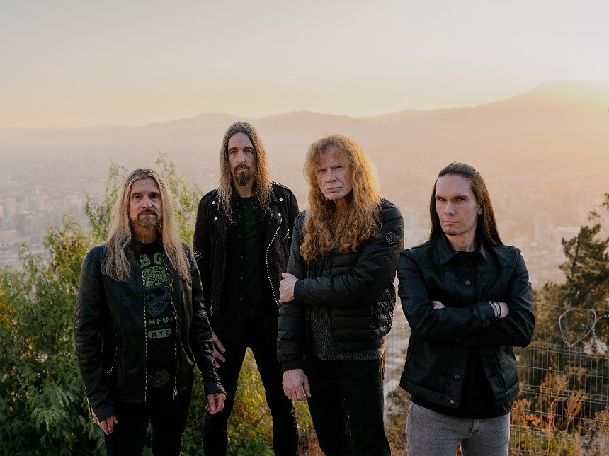 Four long-haired men in a rock band.