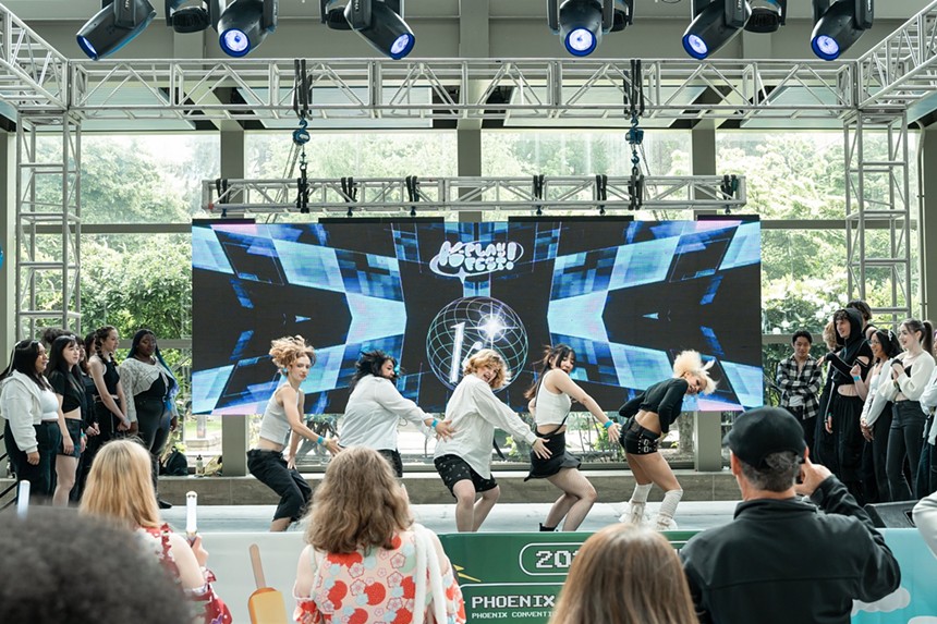 A group of people watching a dance performance.