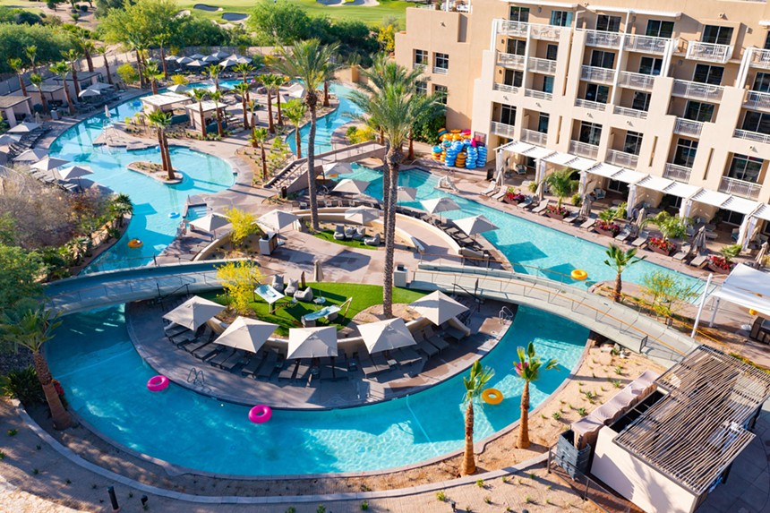 An aerial shot of a resort with a river running through it.