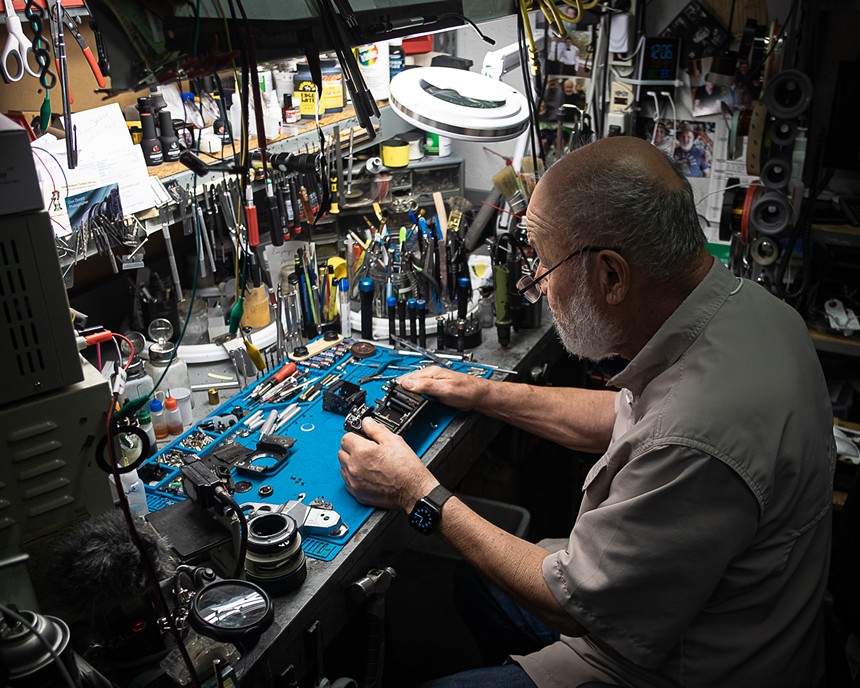 A man working on cameras.