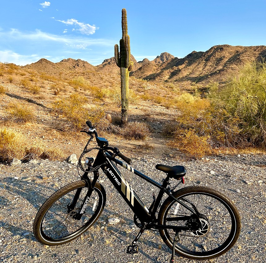 An e-bike parked in front of a saguaro cactus