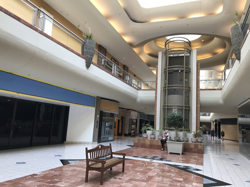 The interior of a vacant indoor shopping mall.