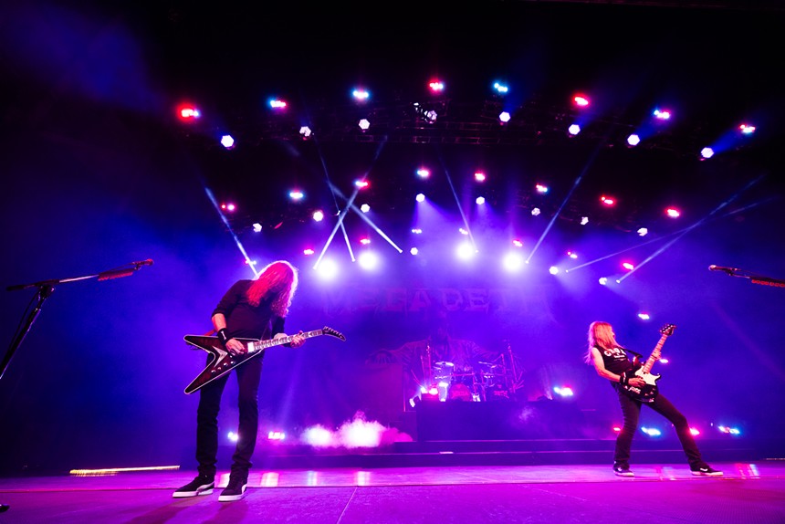 Two men play music on stage.