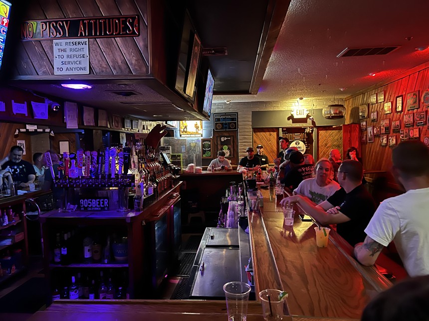 The interior of a bar filled with people.