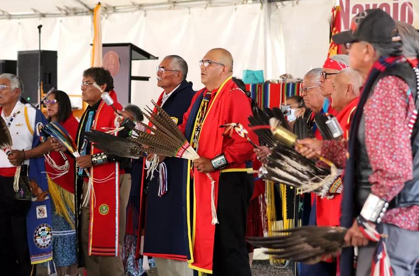Men in robes gather in a musical circle.