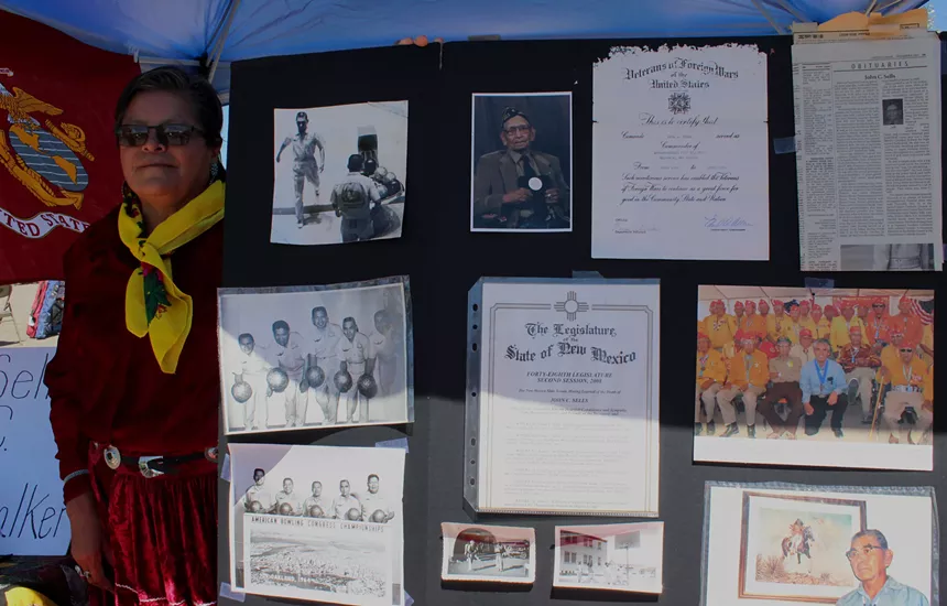 A woman holds a poster.