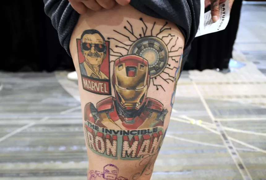 An Iron Man tattoo on a leg.