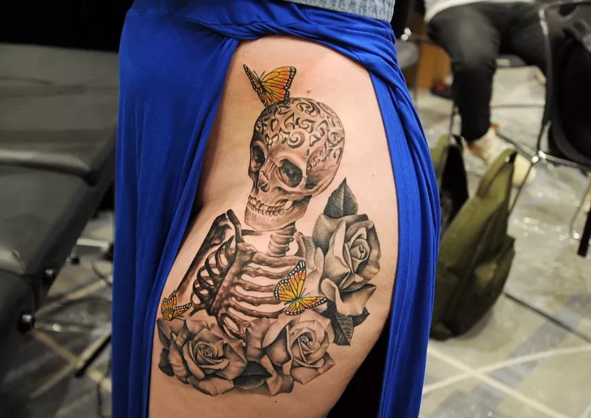 A tattoo with a skeleton and butterflies.