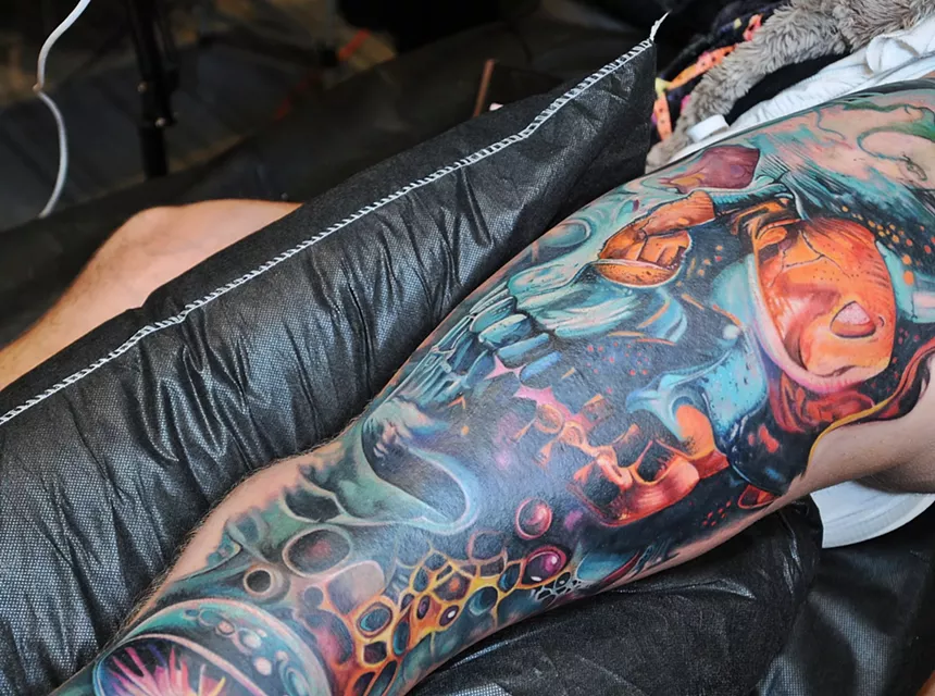 A large skull tattoo covering a leg.