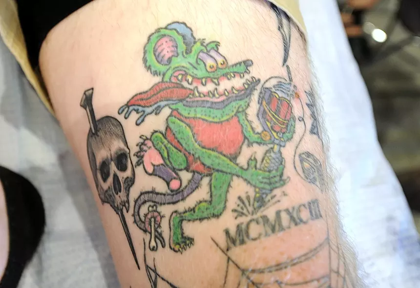 A tattoo of a cartoon rat.