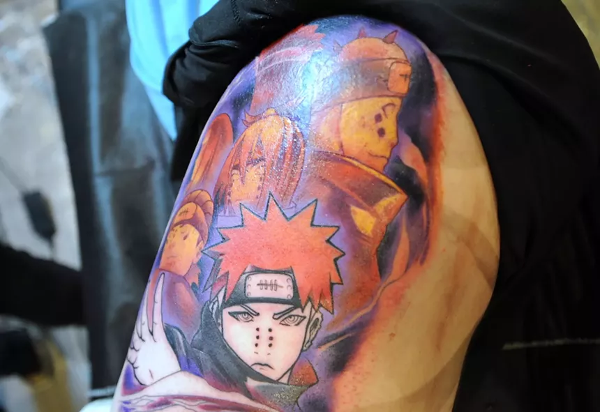 An anime tattoo on a person's shoulder.