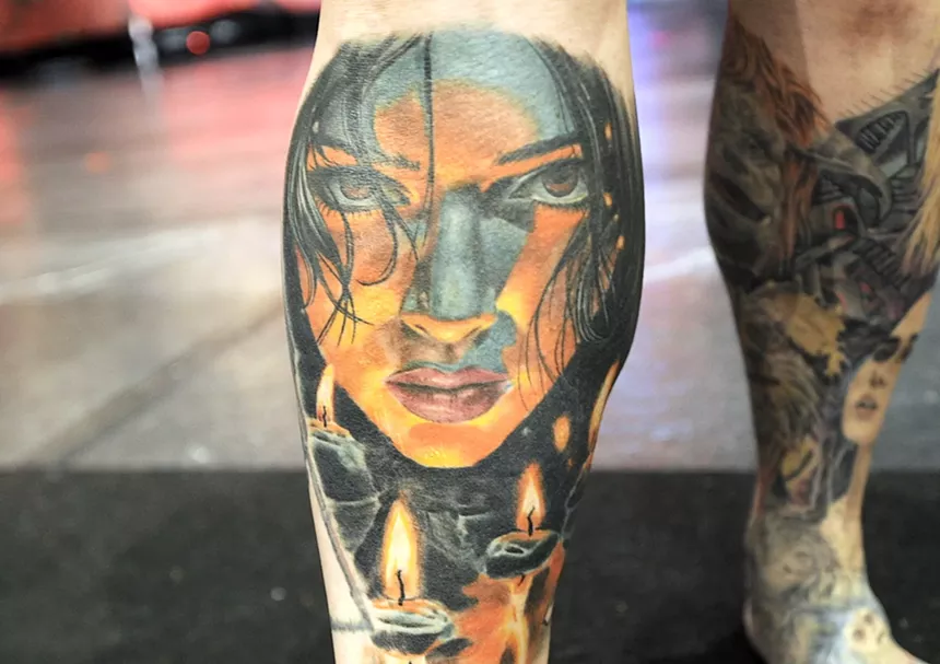 A leg tattoo of a ghostly woman.