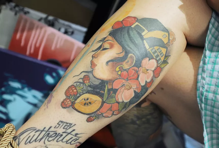 A colorful tattoo on a person's calf.